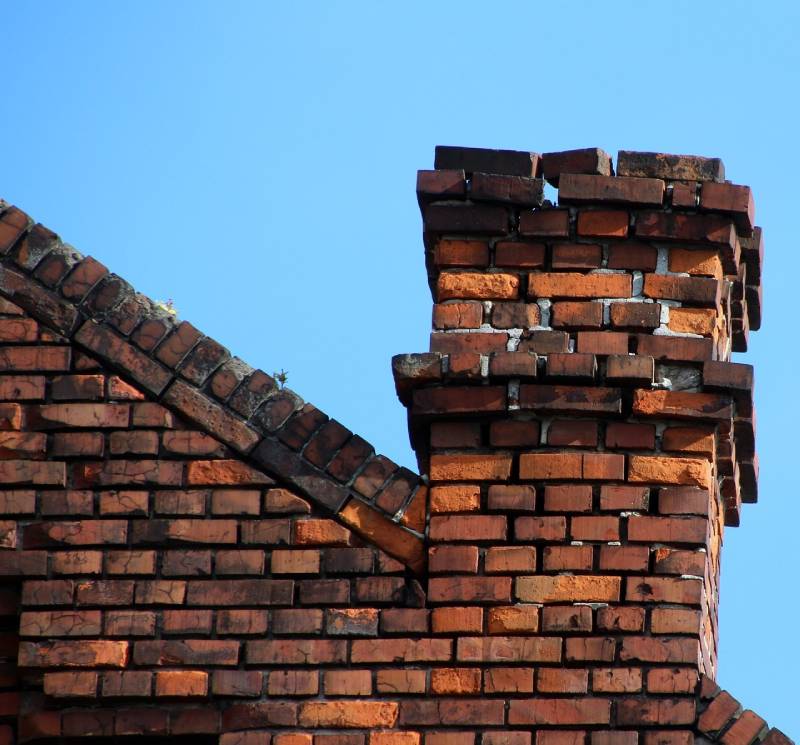 Damaged chimney on an Melrose home showing cracks and missing mortar